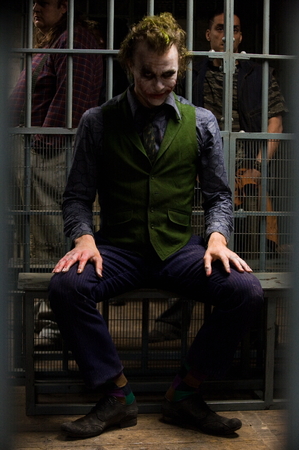 Heath Ledger as The Joker seated in jail cell.jpg